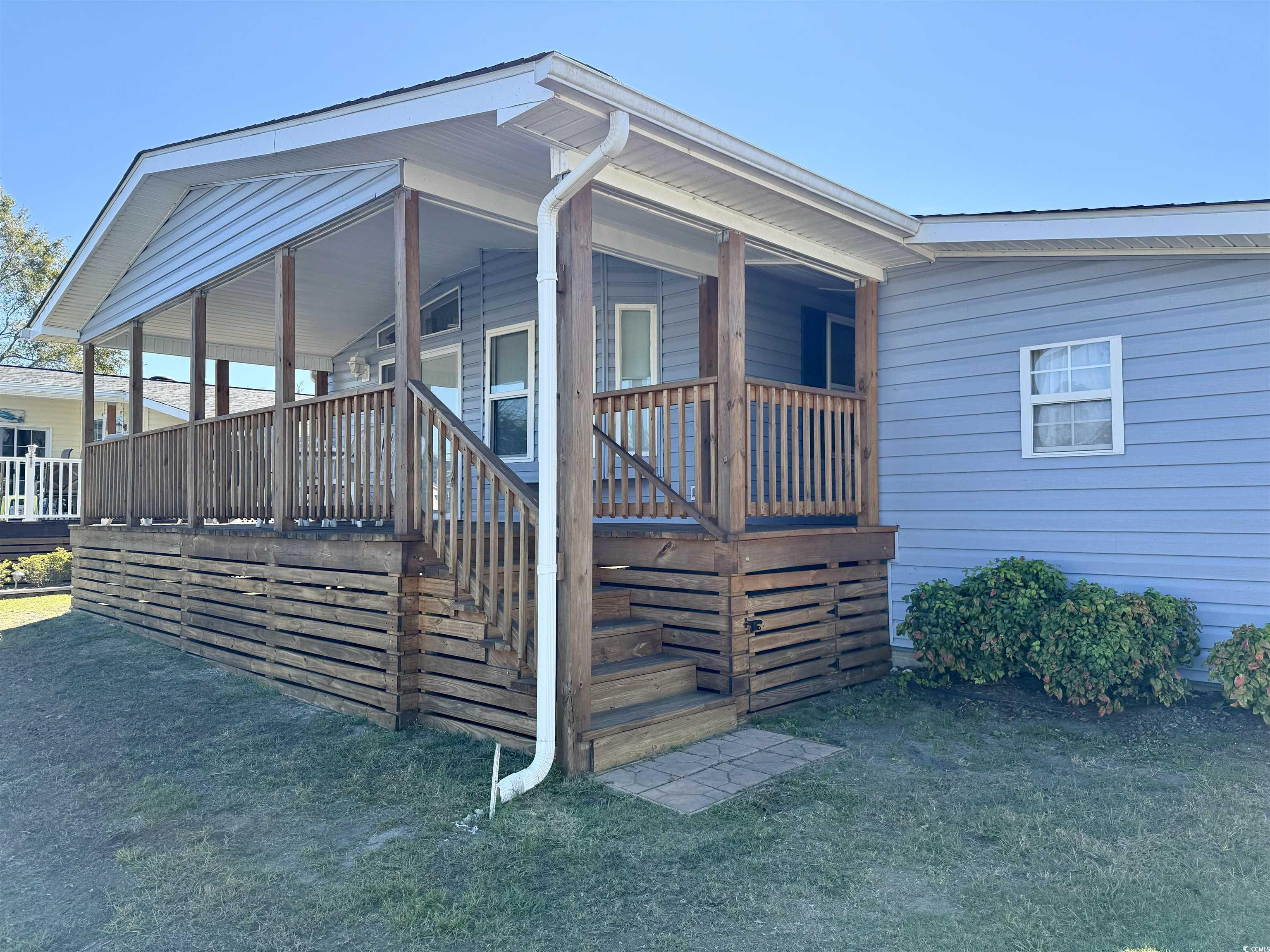 502 Sandpebble Surfside Beach, SC 29575 - Photo 25 of 31 View of property exterior featuring a lawn and a p