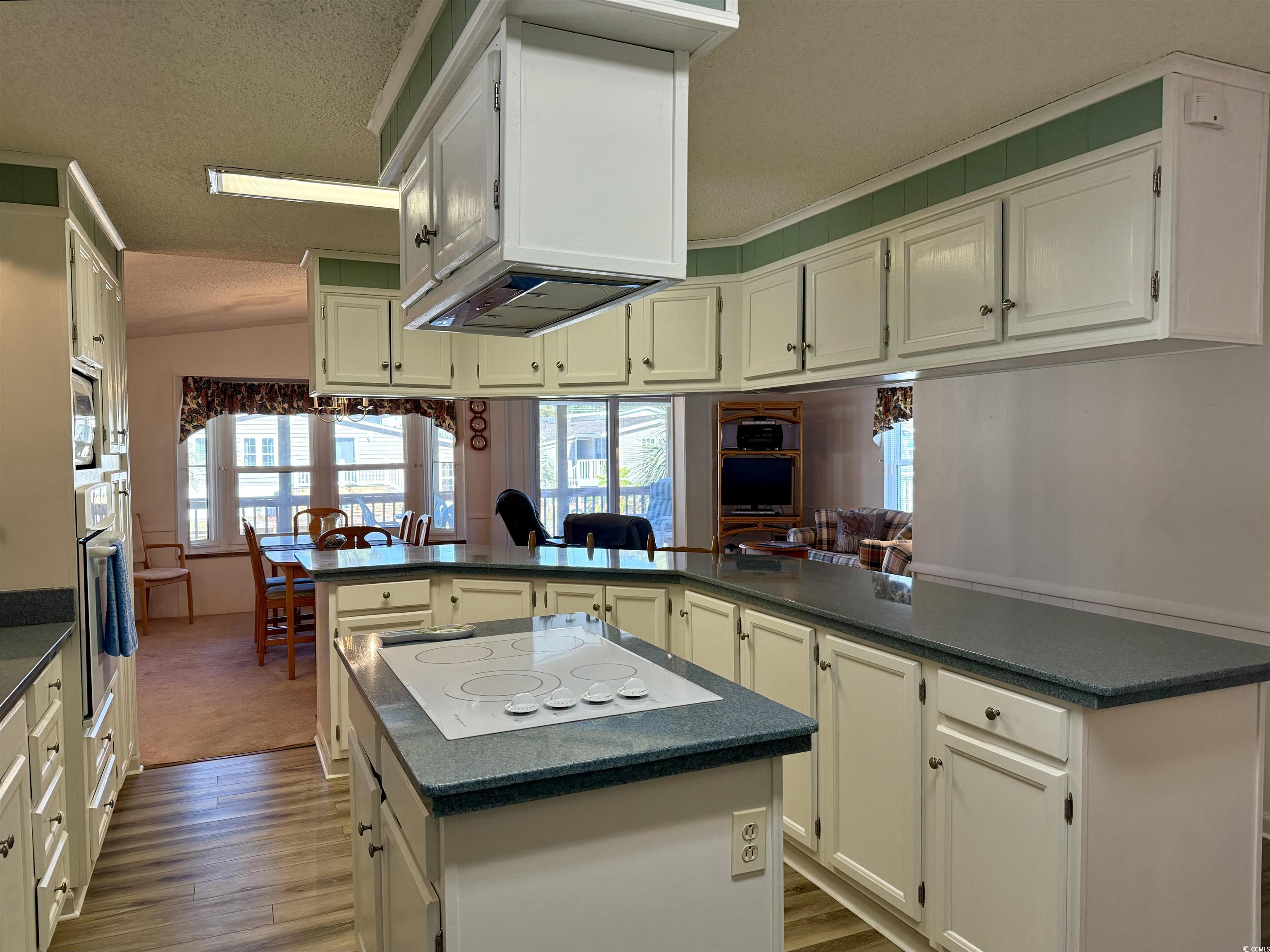 Kitchen featuring wood-type flooring, a kitchen is
