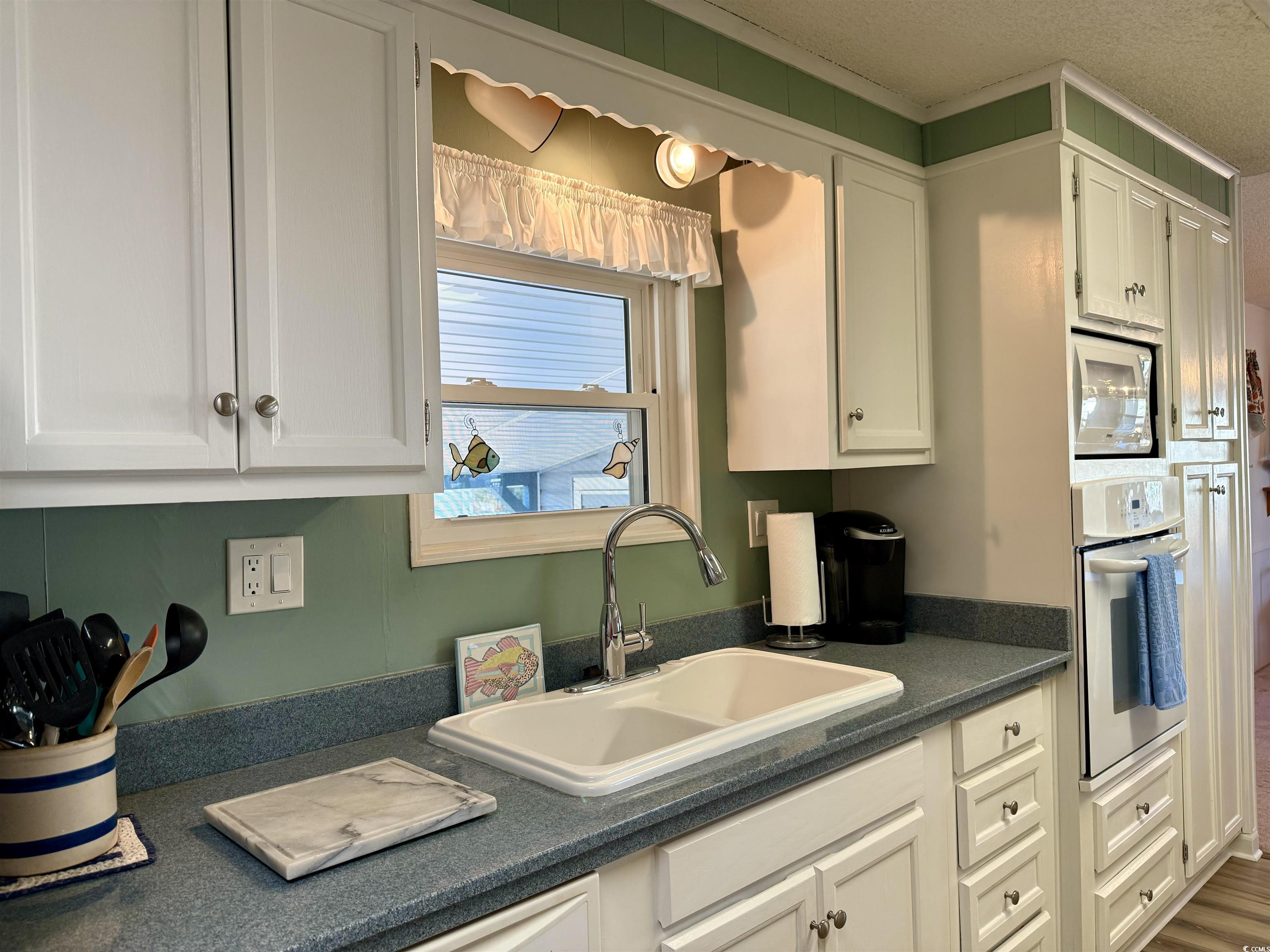 Kitchen featuring stainless steel oven, wood-type