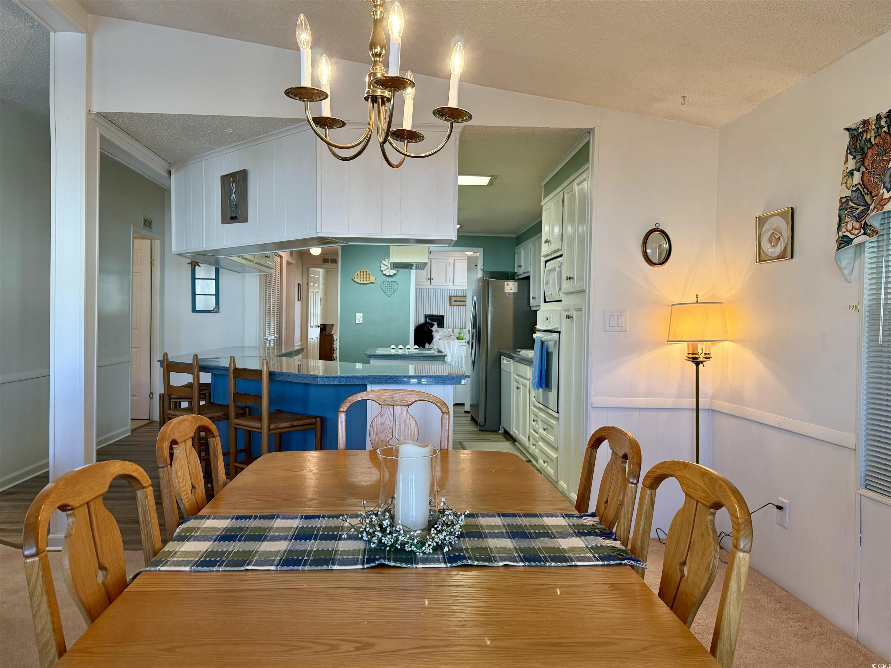 Dining area featuring vaulted ceiling, light color