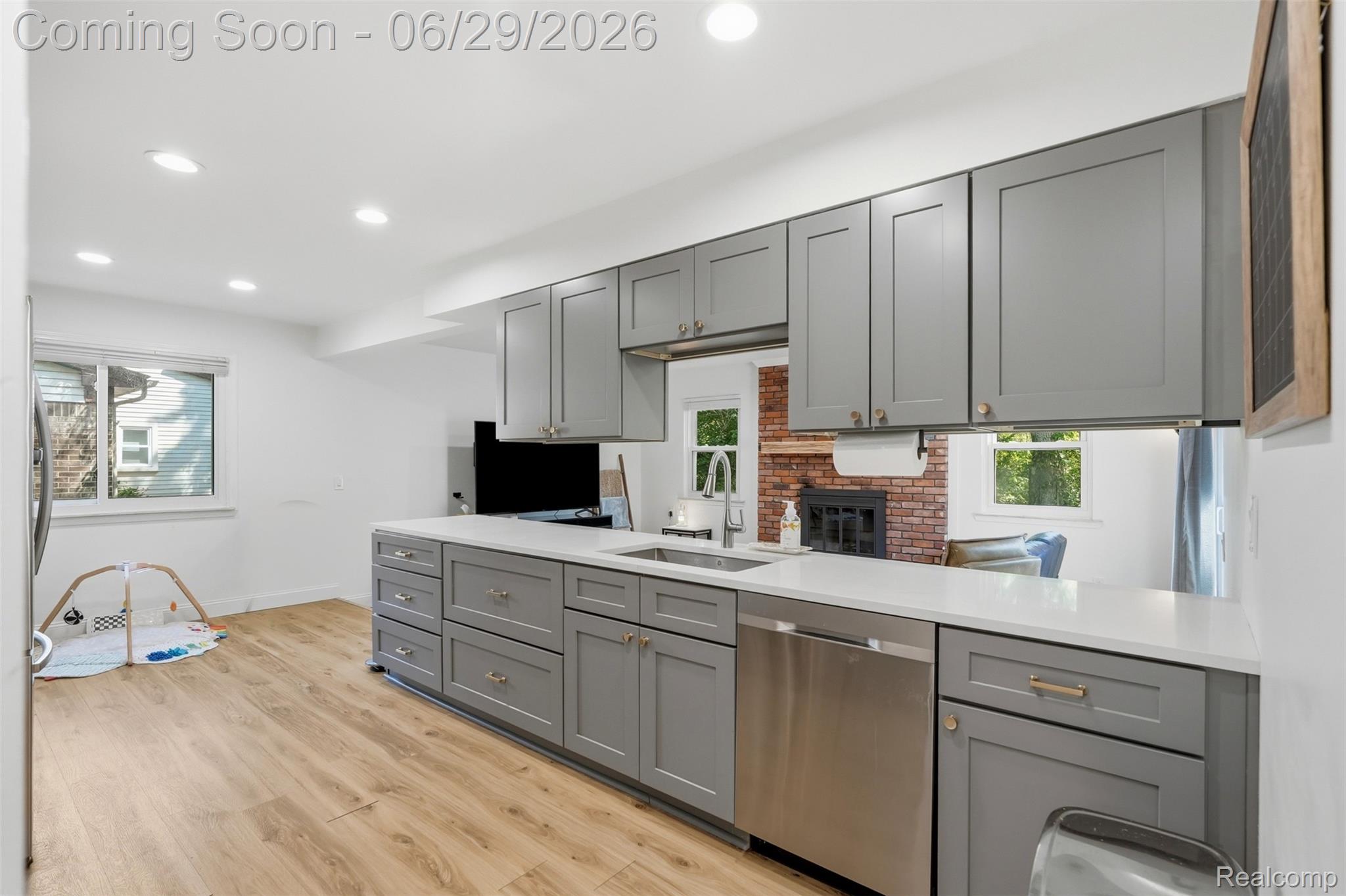 45179 Rudgate Road Canton, MI 48188 - Photo 13 of 48 Contemporary kitchen featuring gray shaker-style cabinetry, white countertops, and wood-finish flooring