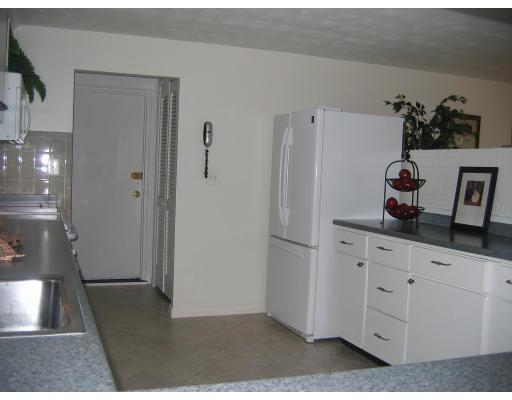 28 Wentworth Road Canton, MA 02021 - Photo 7 of 10 a kitchen with white cabinets and refrigerator