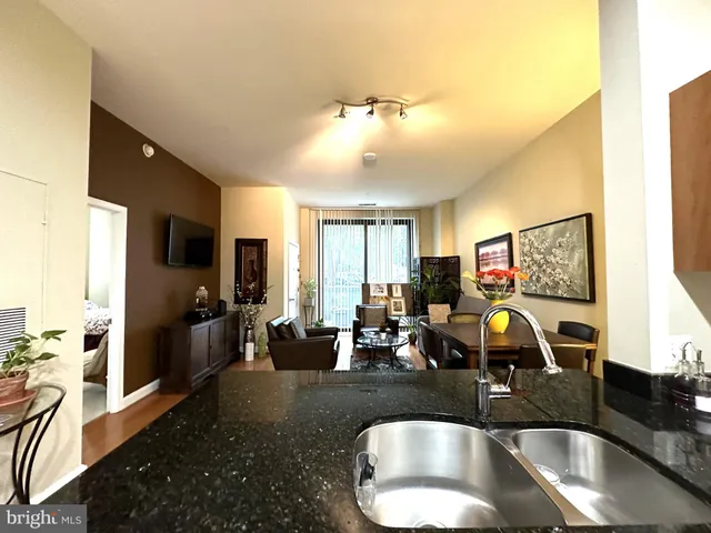 a kitchen with sink and refrigerator