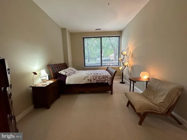 a bedroom with a bed and a couch