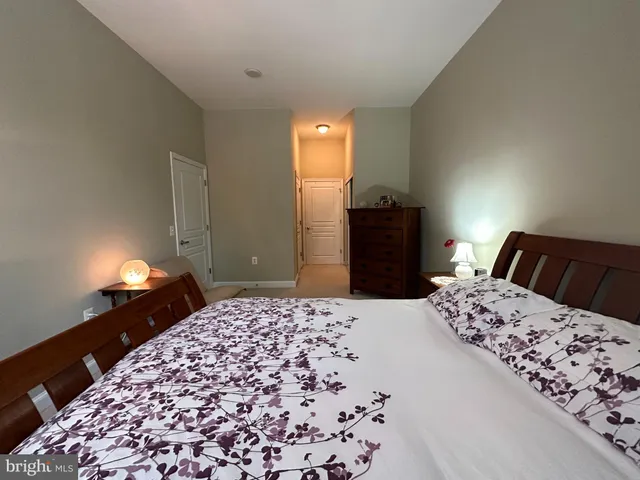 a bedroom with a bed and a lamp