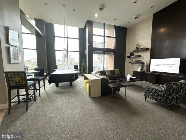 a lobby with furniture and floor to ceiling window