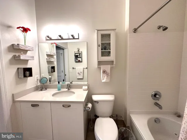 a bathroom with a sink mirror vanity and toilet