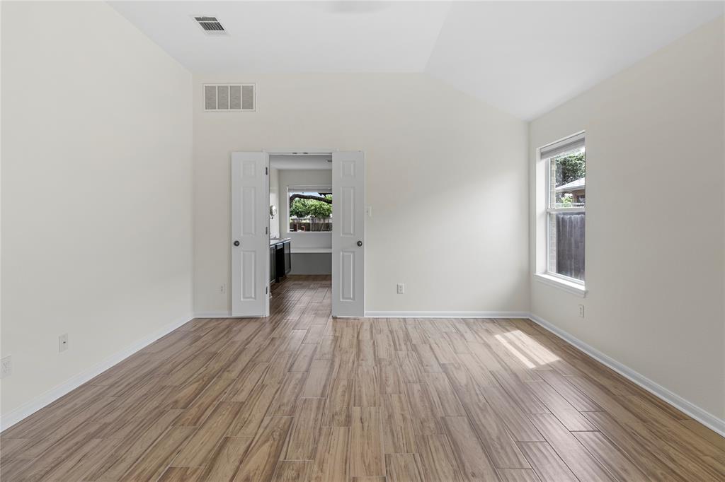 1011 St Helena Drive Leander, TX 78641 - Photo 10 of 11 Empty room featuring light wood-style flooring and lofted ceiling