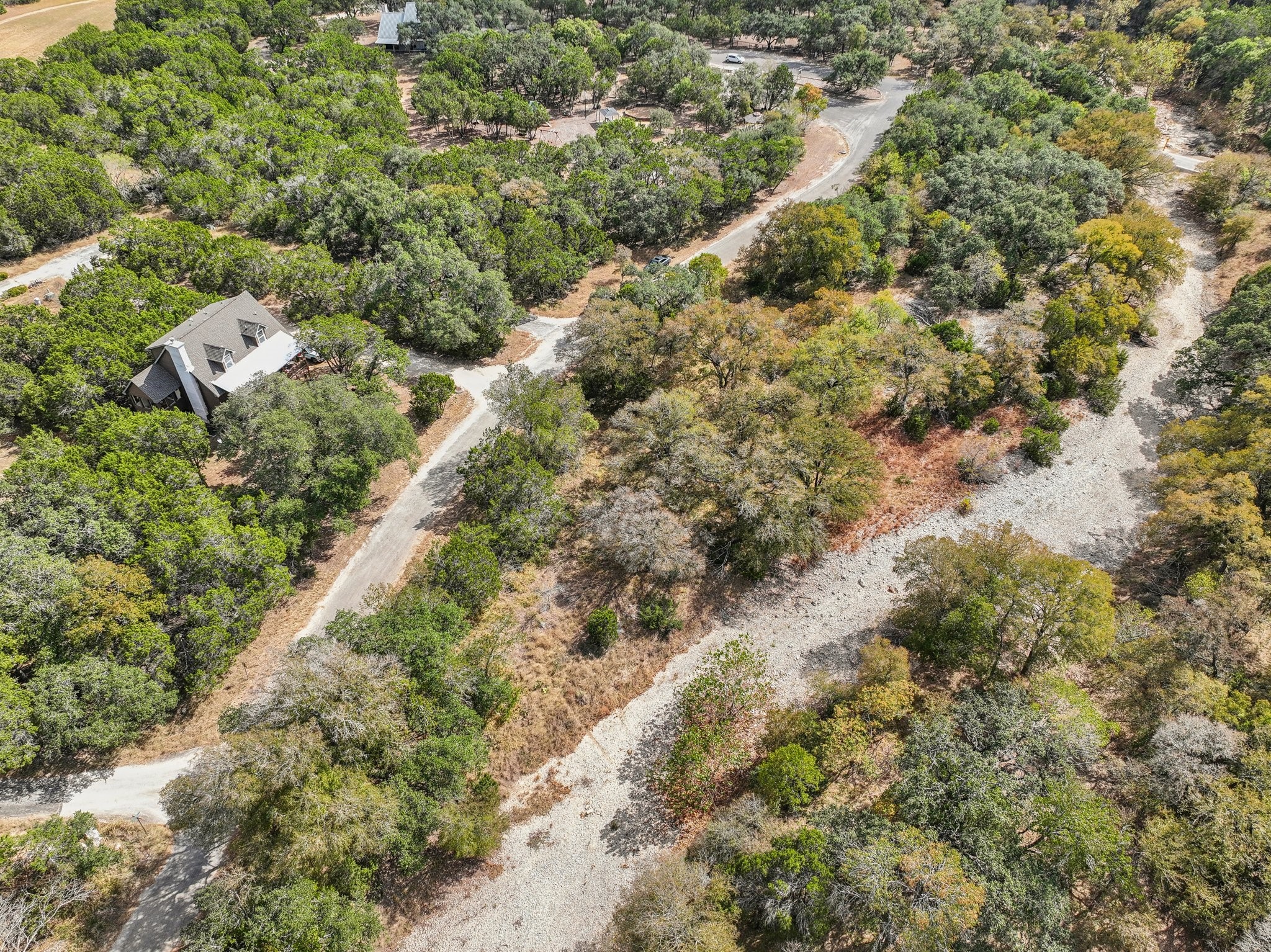 9 East Valley Spring Road Wimberley, TX 78676 - Photo 9 of 11 an aerial view of residential houses with outdoor space and trees