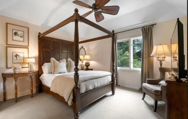 a bedroom with a bed couch and a window