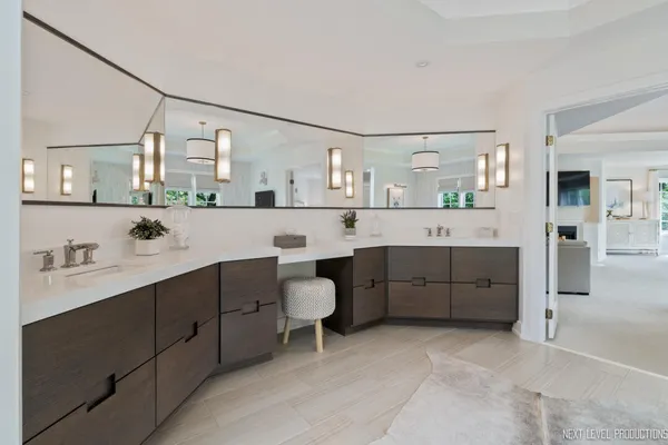 a bathroom with a sink a toilet and mirror