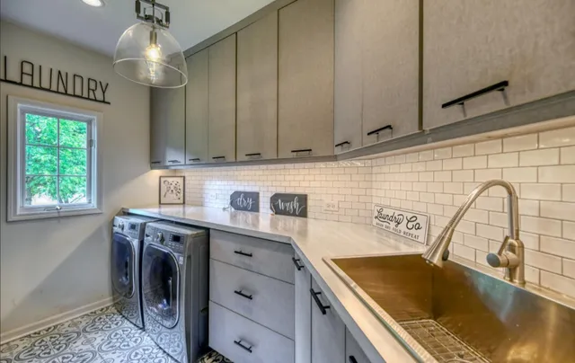 a kitchen with a sink cabinets and window