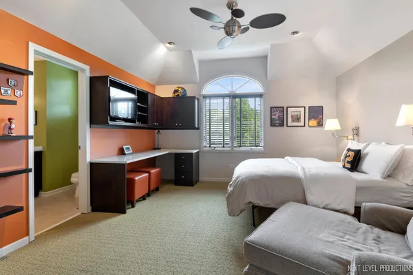 a living room with couches and kitchen view of kitchen