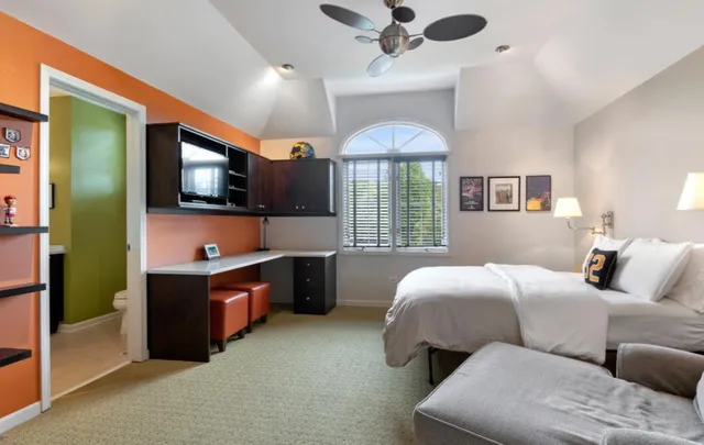 a bedroom with bed and a flat screen tv