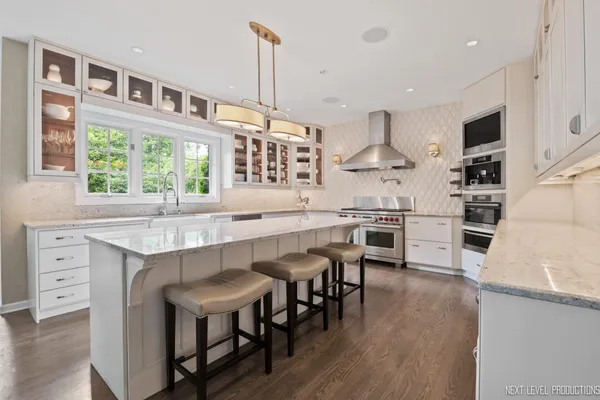 a kitchen with white cabinets stove and refrigerator