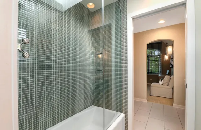 a bathroom with a bathtub and shower