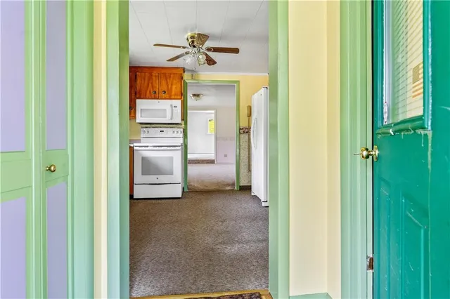 a view of a hallway with wooden shelves