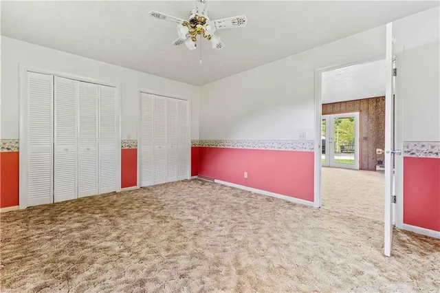 a view of a livingroom with a ceiling fan and window