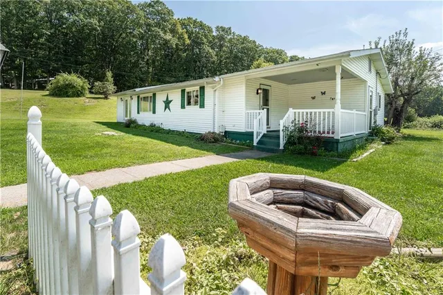 a view of house with backyard and patio