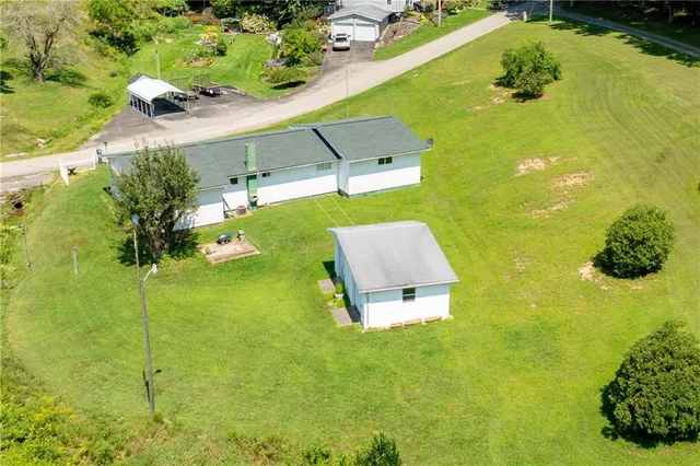 a aerial view of a house with a yard