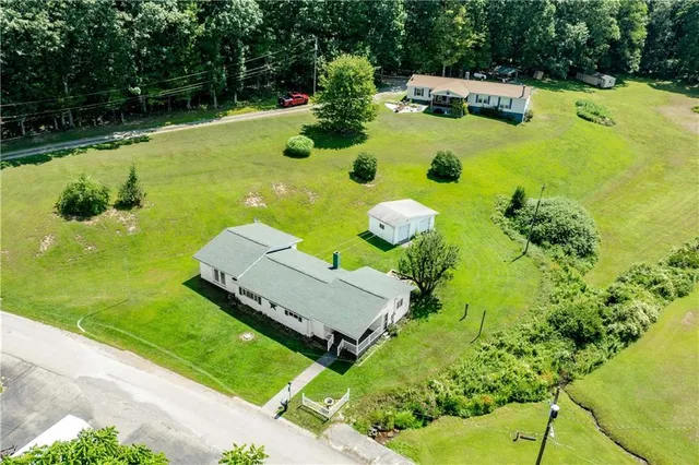 a aerial view of a house with yard swimming pool and outdoor seating