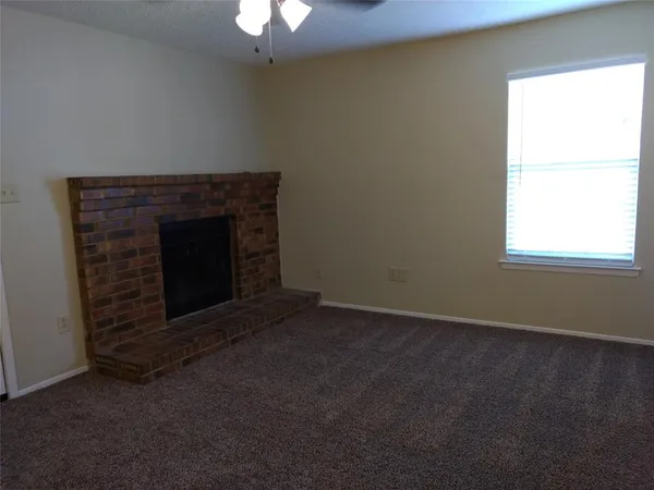 an empty room with a fireplace