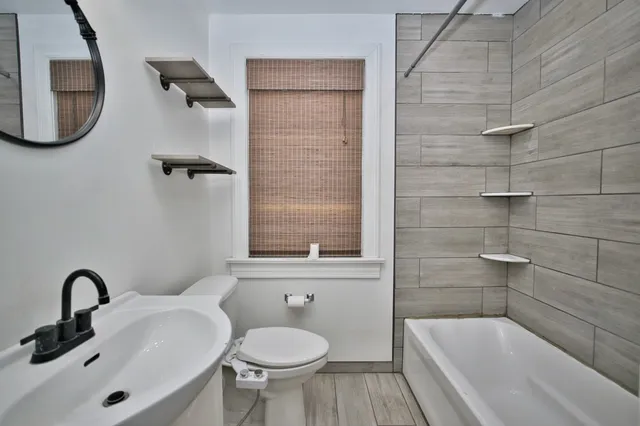 a bathroom with a sink a toilet and bathtub