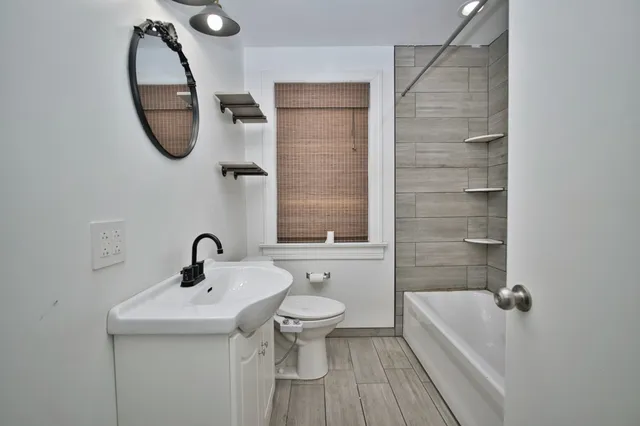 a bathroom with a sink a toilet and a bathtub