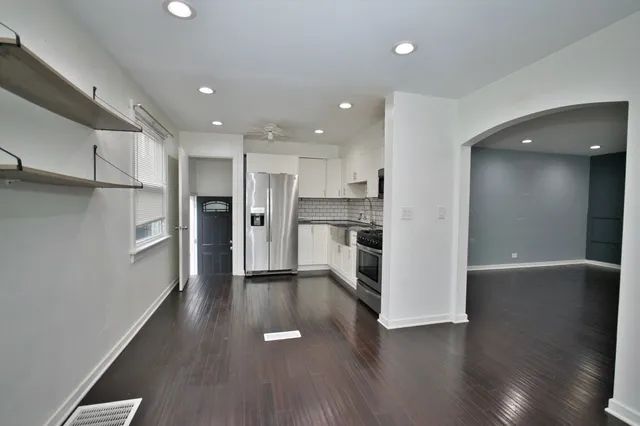 a view of a kitchen with a sink and a refrigerator