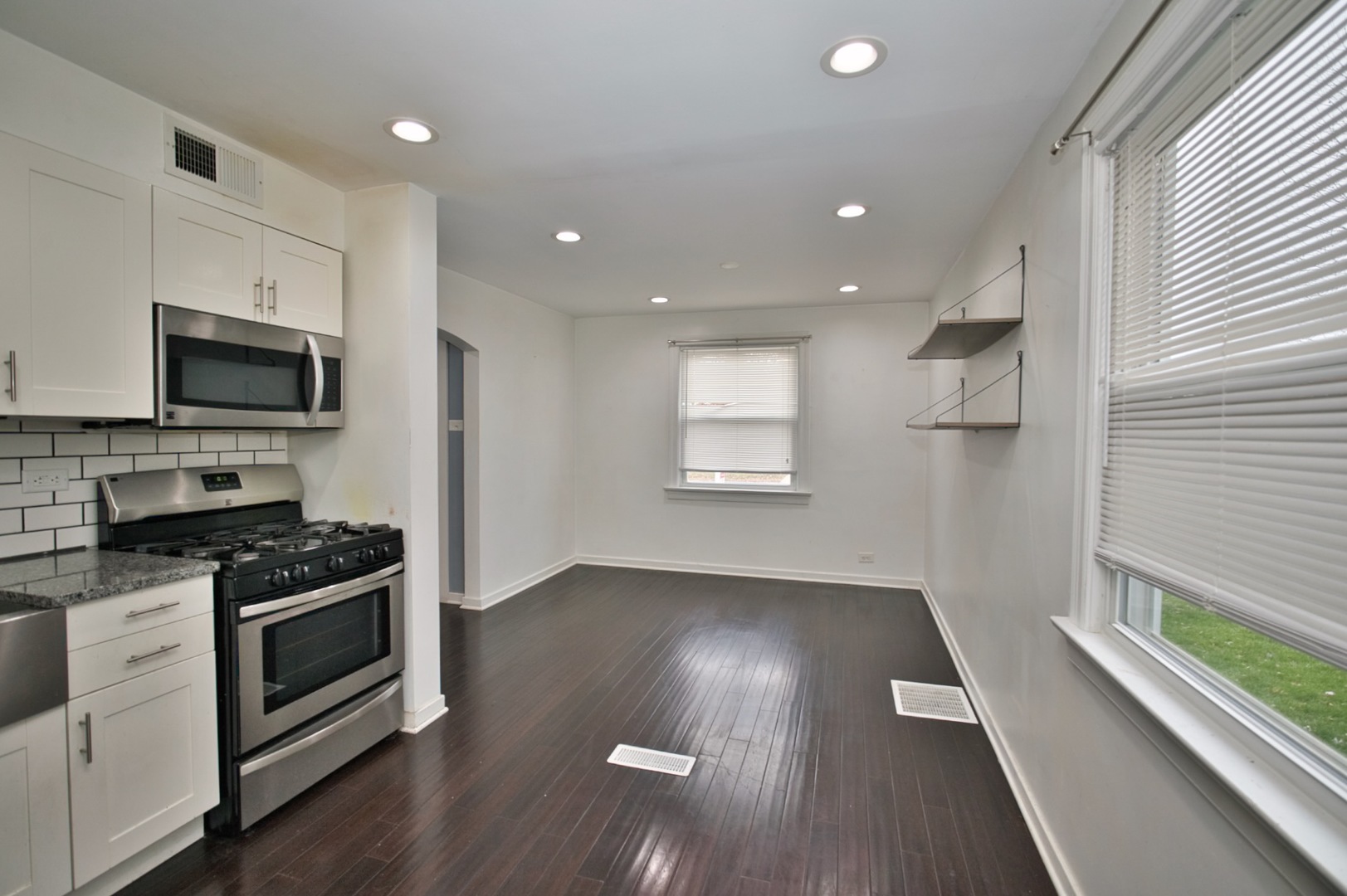 4122 Clinton Avenue Stickney, IL 60402 - Photo 20 of 44 a kitchen with granite countertop a stove and a hard wood floor