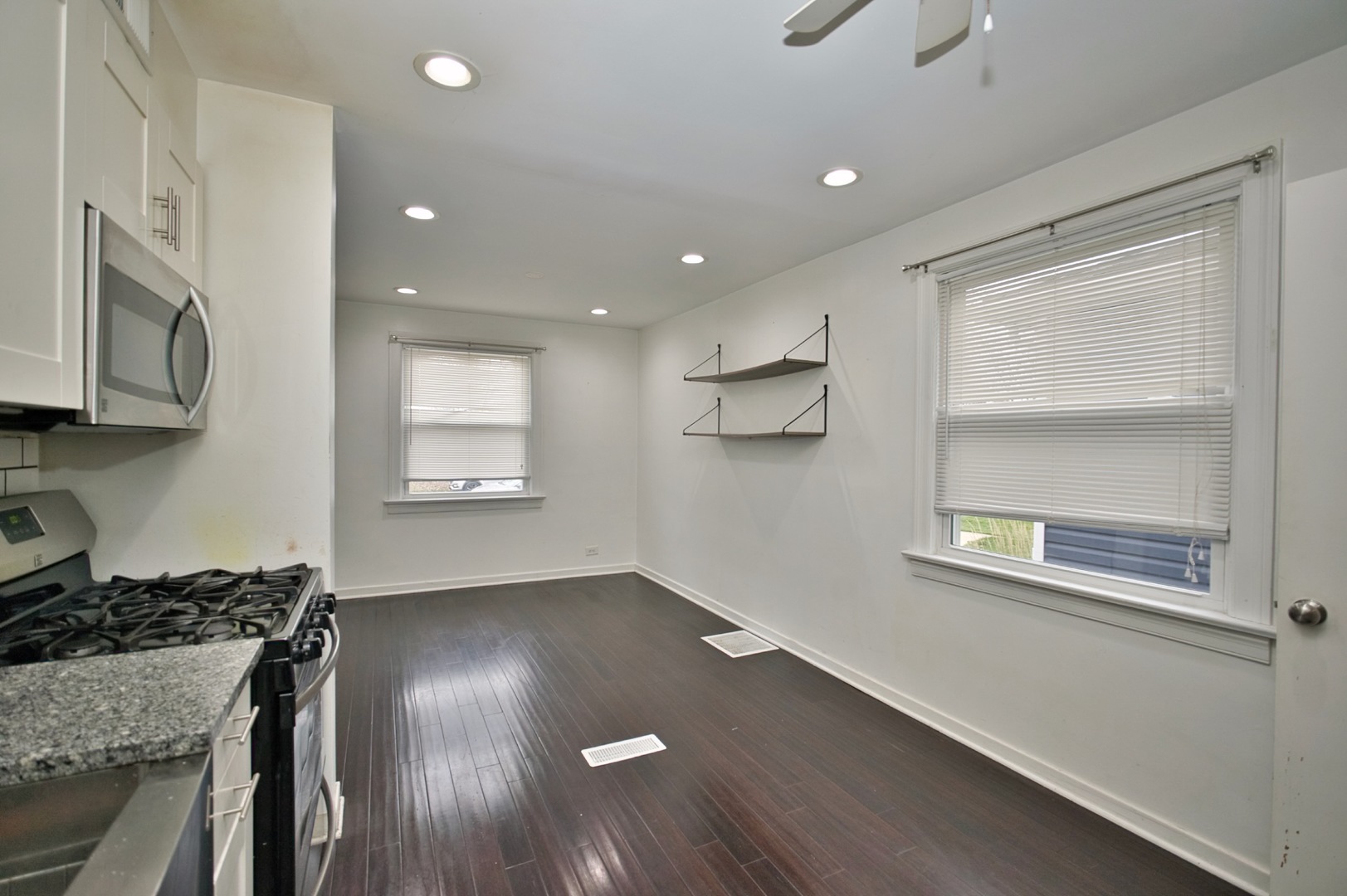 4122 Clinton Avenue Stickney, IL 60402 - Photo 21 of 44 a view of a kitchen with a stove wooden cabinets and a refrigerator