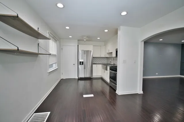 a view of kitchen view wooden floors appliances and cabinets