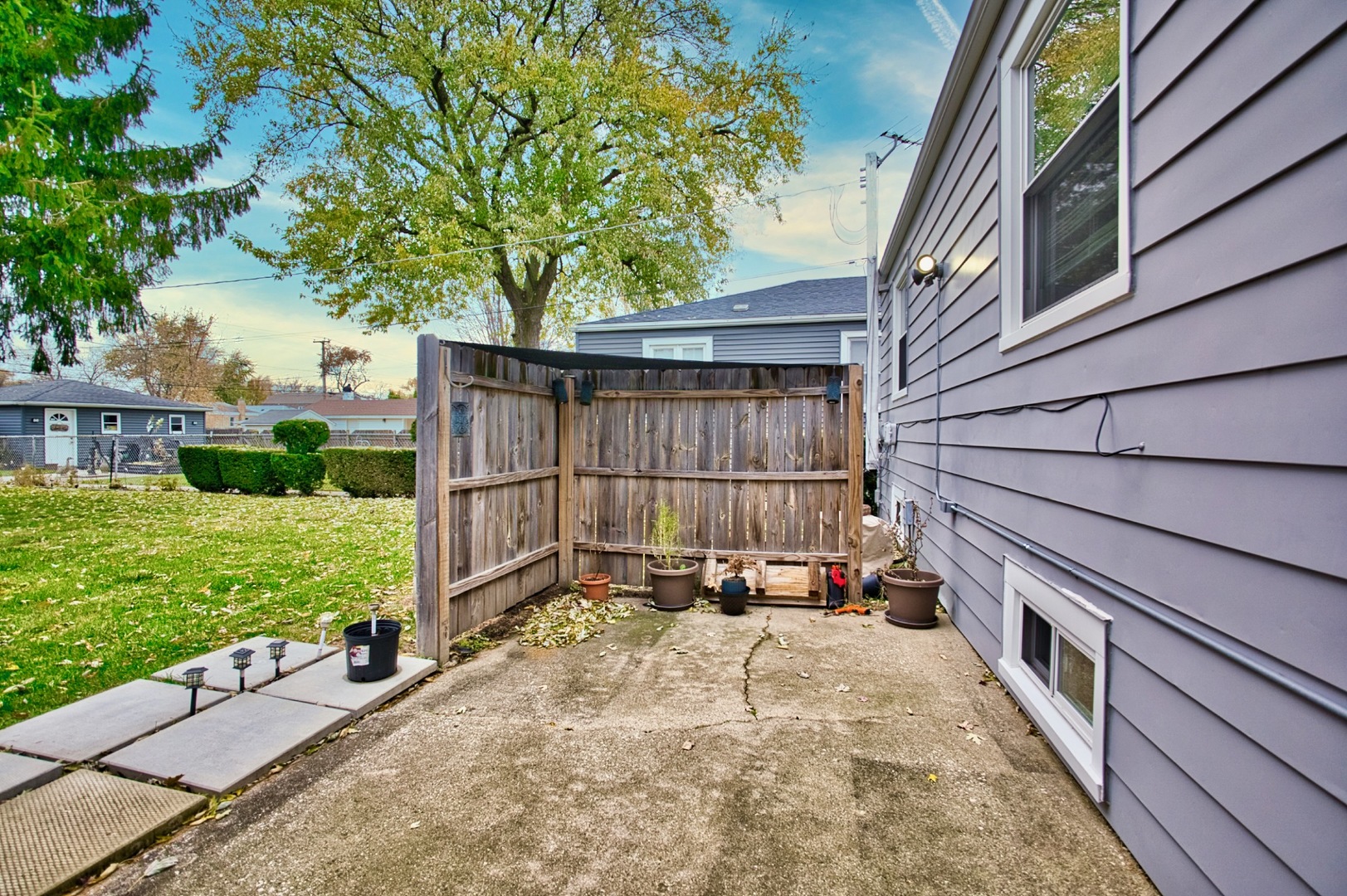 4122 Clinton Avenue Stickney, IL 60402 - Photo 33 of 44 a view of backyard with large trees and a wooden fence