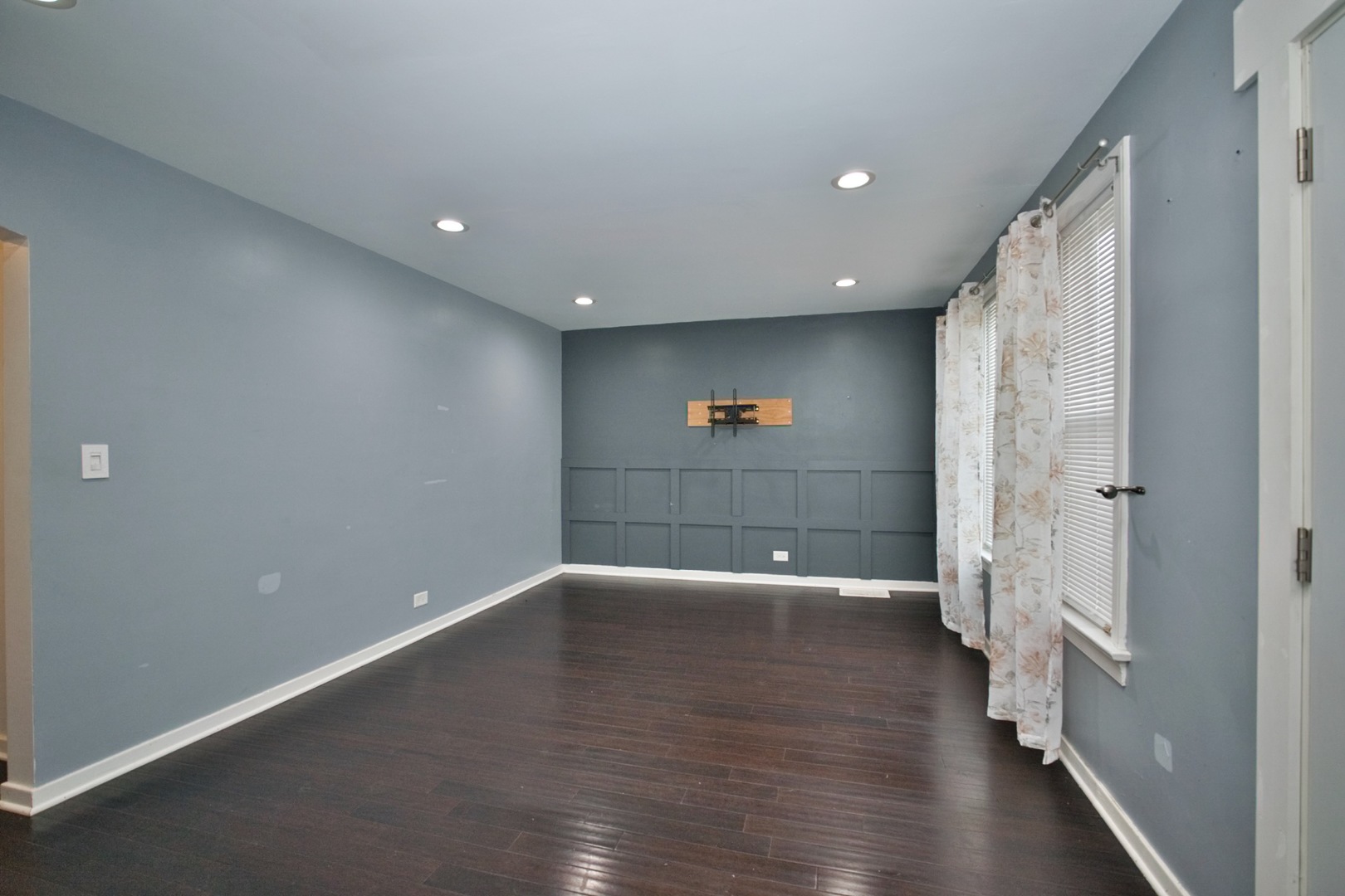4122 Clinton Avenue Stickney, IL 60402 - Photo 4 of 44 an empty room with wooden floor and windows