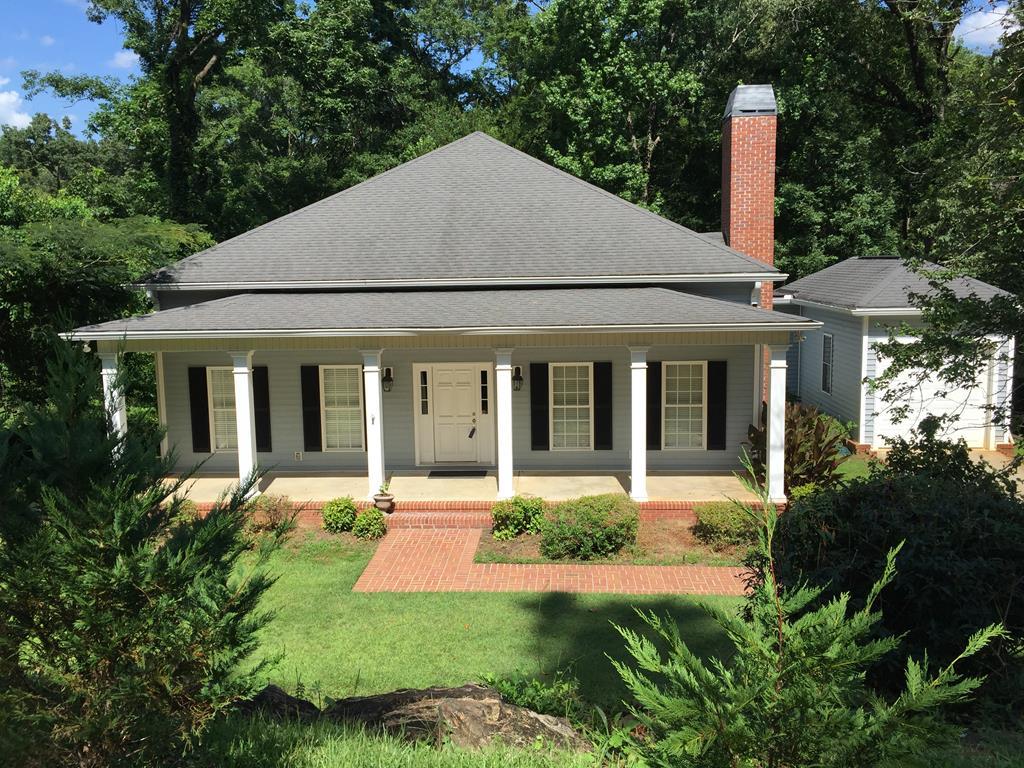 1257 Bass Road Macon, GA 31210 - Photo 1 of 13 a front view of a house with a yard table and chairs