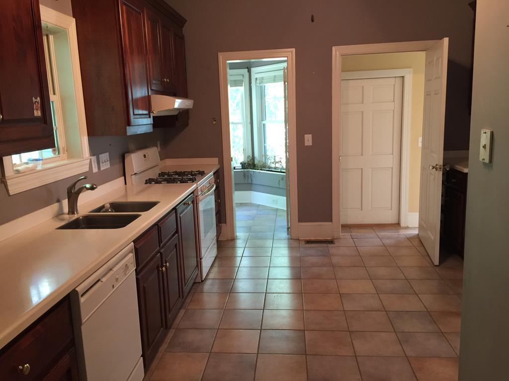 1257 Bass Road Macon, GA 31210 - Photo 2 of 13 a kitchen with a sink a stove and a microwave