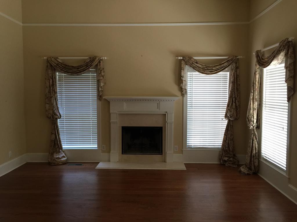 1257 Bass Road Macon, GA 31210 - Photo 7 of 13 a view of an empty room with wooden floor and a window