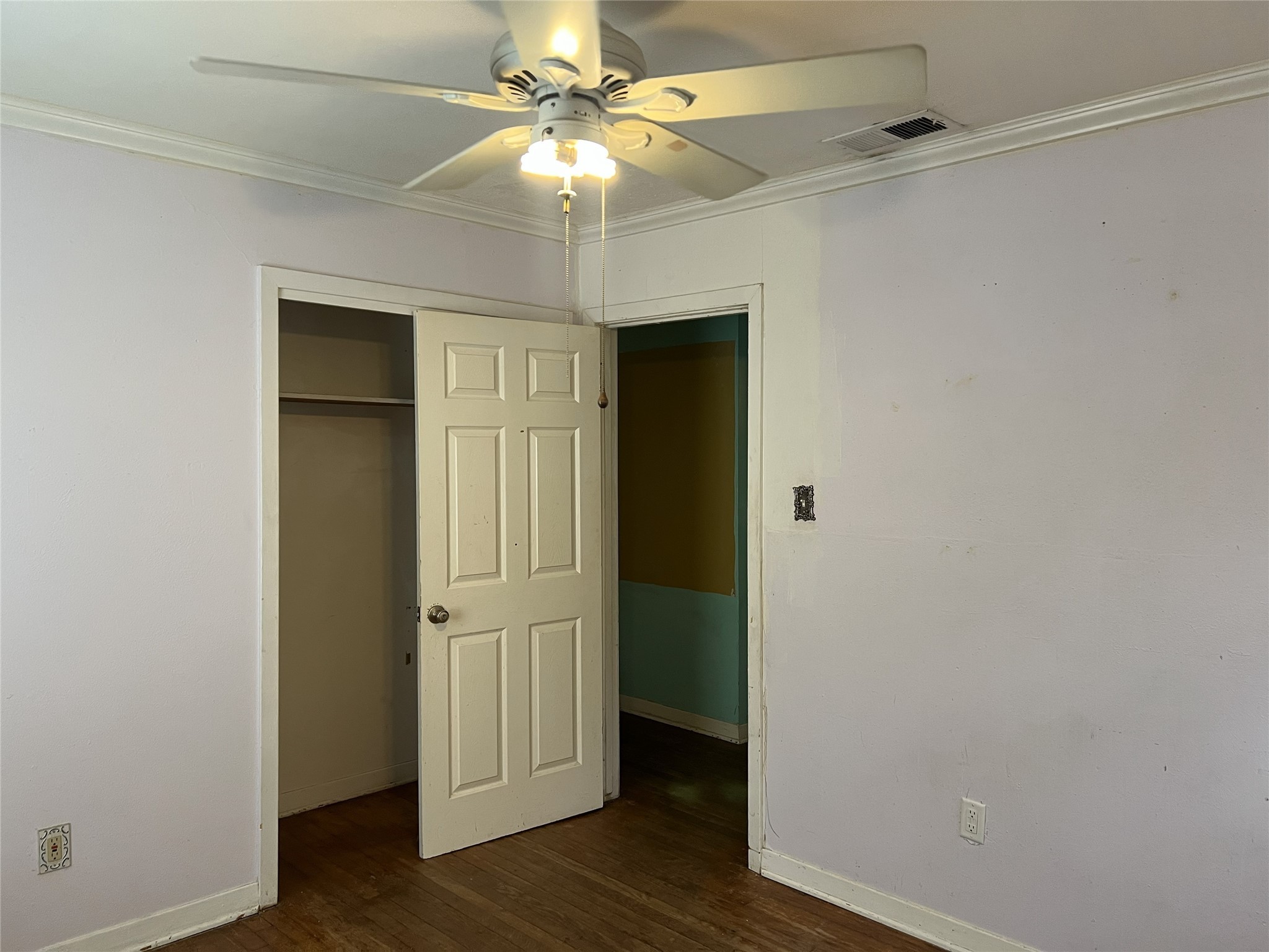 403 Wagers Street Conroe, TX 77301 - Photo 16 of 22 an empty room with wooden floor closet and windows