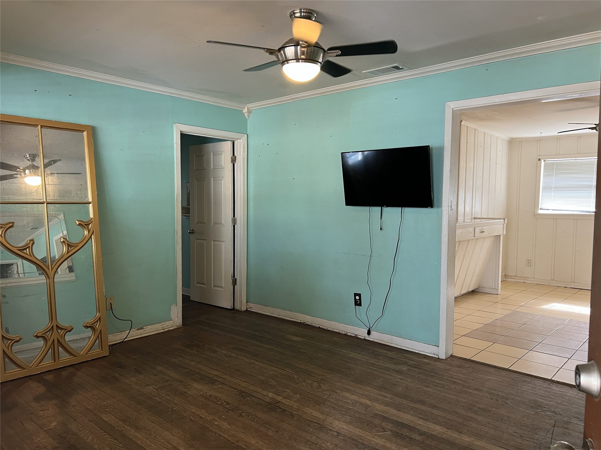 403 Wagers Street Conroe, TX 77301 - Photo 5 of 22 an empty room with wooden floor fan and windows