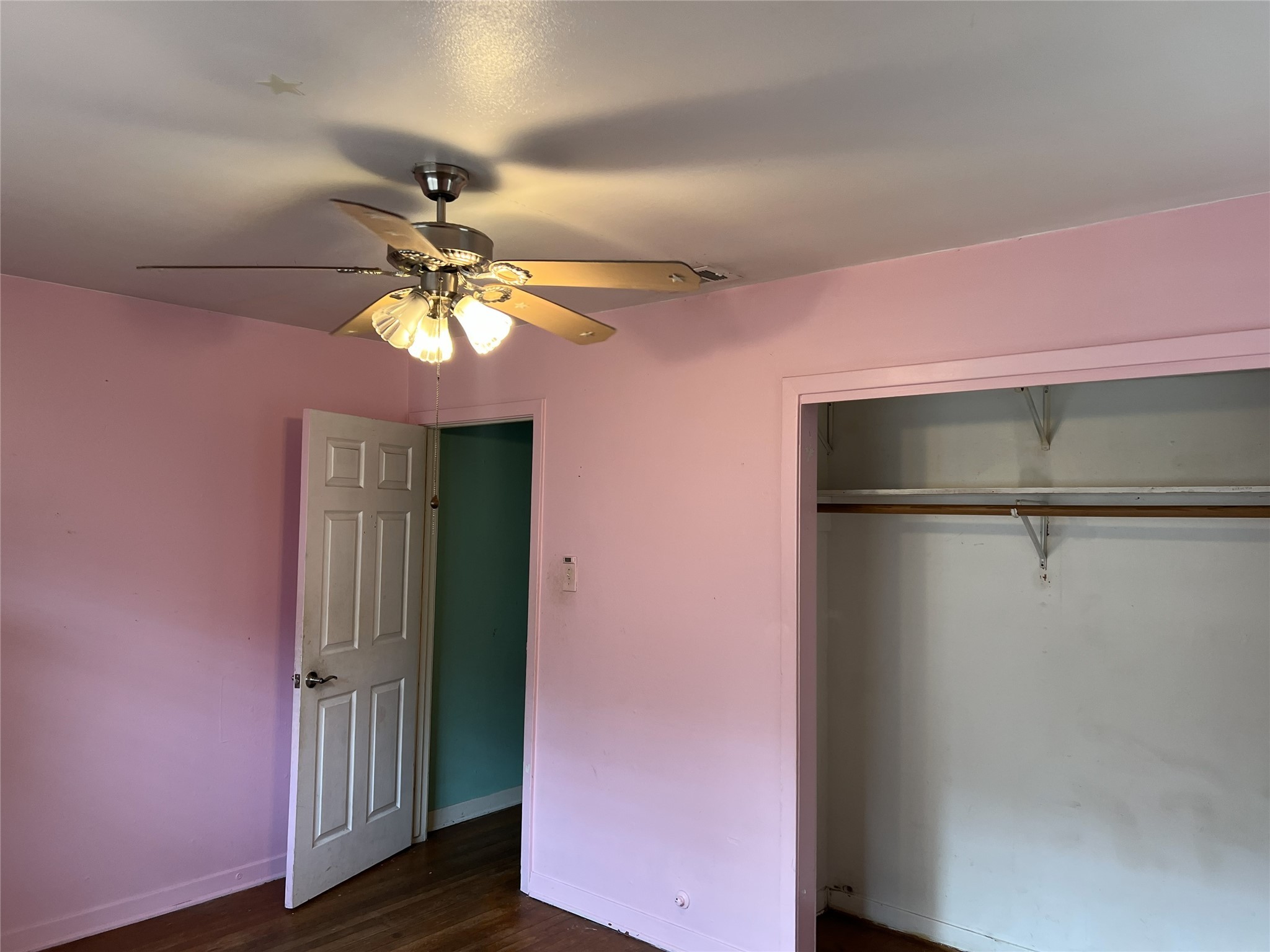 403 Wagers Street Conroe, TX 77301 - Photo 10 of 22 a view of a livingroom with a chandelier fan and a wooden floor