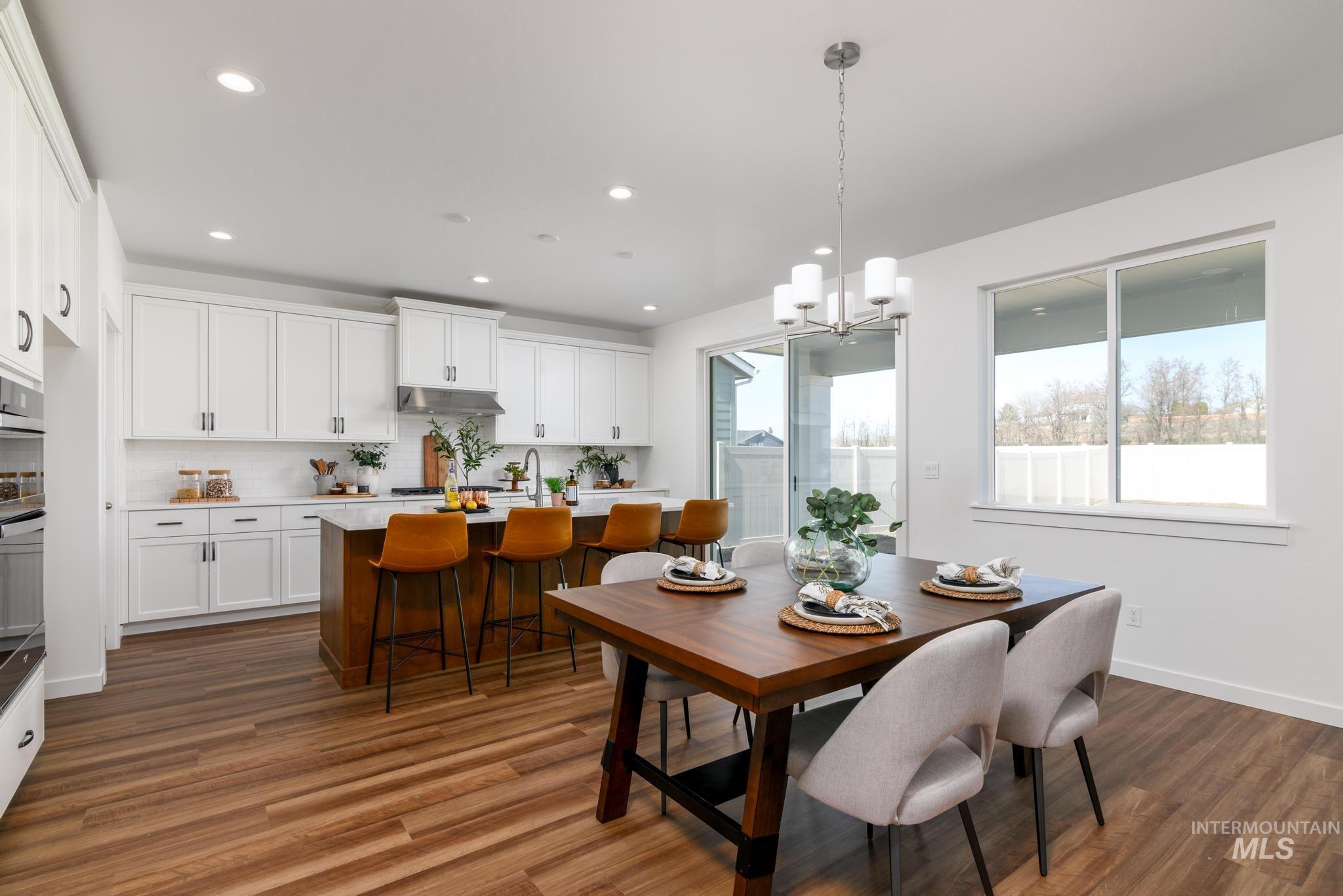 1244 Grassland Street Middleton, ID 83644 - Photo 4 of 10 Dining room featuring a chandelier and dark wood-style flooring