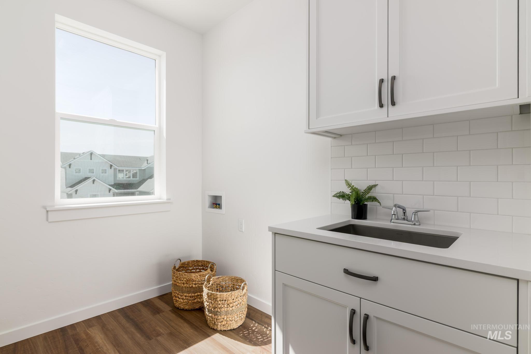 1244 Grassland Street Middleton, ID 83644 - Photo 9 of 10 Laundry room with hookup for a washing machine, cabinet space, and dark wood-type flooring