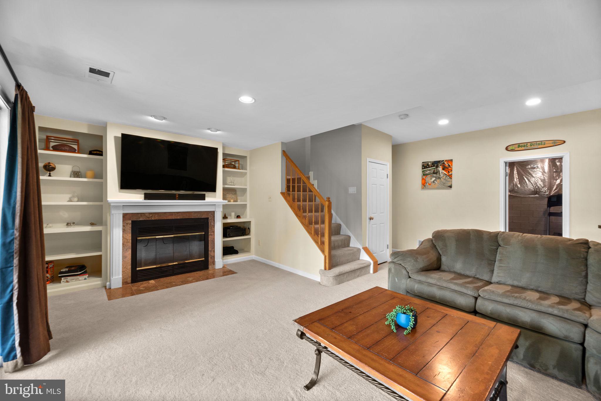 5239 Columbia Road, Unit 5 70 Columbia, MD 21044 - Photo 40 of 59 Lower level; wood fireplace and built-ins.