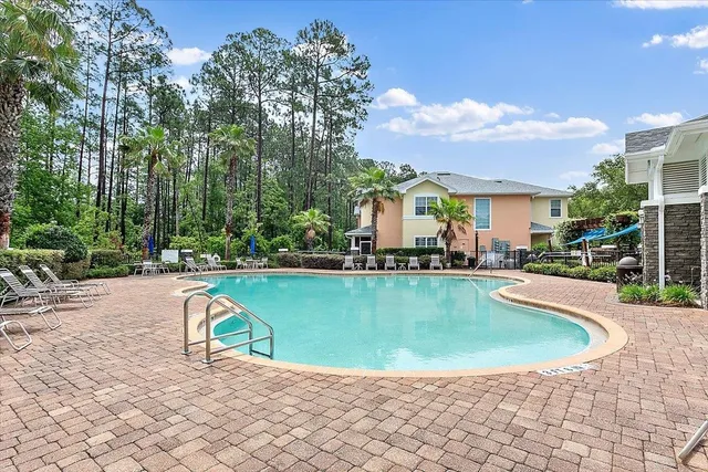 a view of a swimming pool and lounge chairs