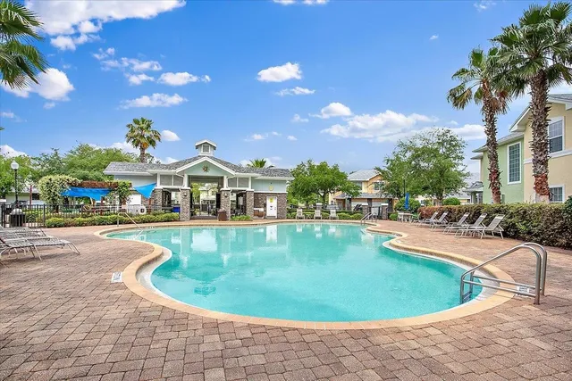 a view of a swimming pool with outdoor seating