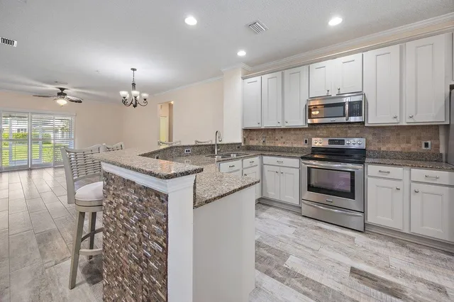 a kitchen with a sink stove and cabinets