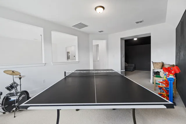 a room with a flat screen tv and a couch