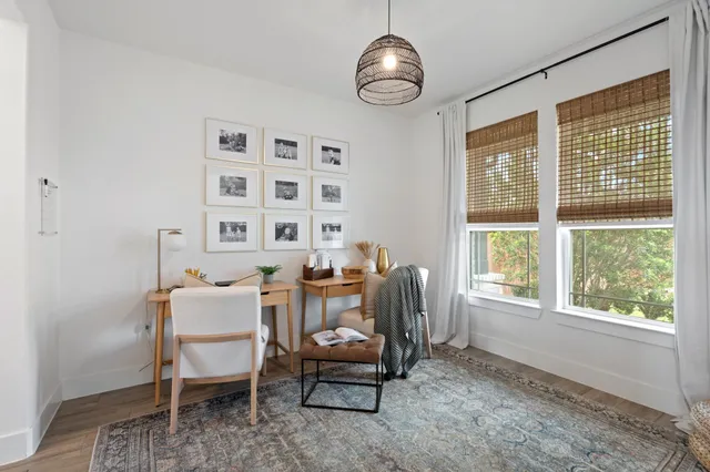 a dining room with furniture a rug and a window