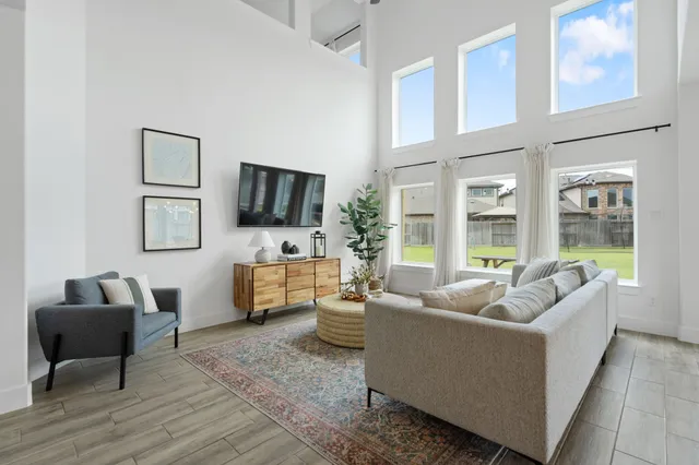 a living room with furniture and a flat screen tv