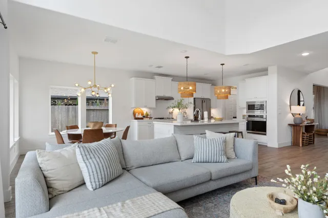 a view of a living room kitchen and a large window